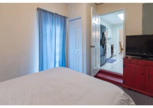 a bedroom with a bed and a flat screen tv at Home away from Home! in Deltona