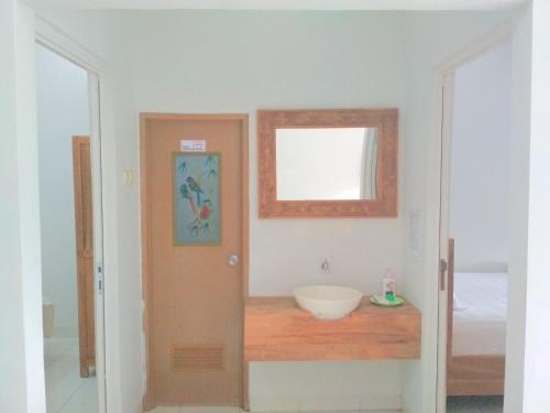 a bathroom with a sink and a mirror at Wisma Andany in Jepara