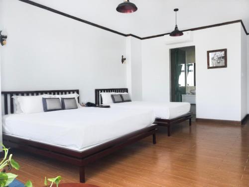 Giường trong phòng chung tại Origo Hotel Da Nang