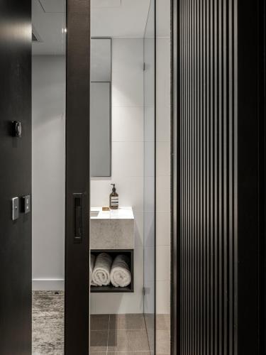 a bathroom with a sink and a mirror at Mercure Sydney Rouse Hill in Kellyville