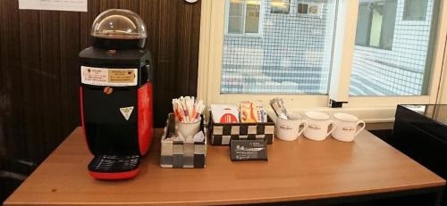 a coffee maker sitting on top of a table at LJ Hotel in Kaohsiung