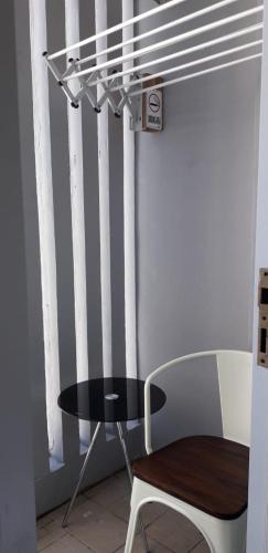 a table and a chair next to a window at Vida View Apartement, Tower Asthon Unit 20 P in Makassar