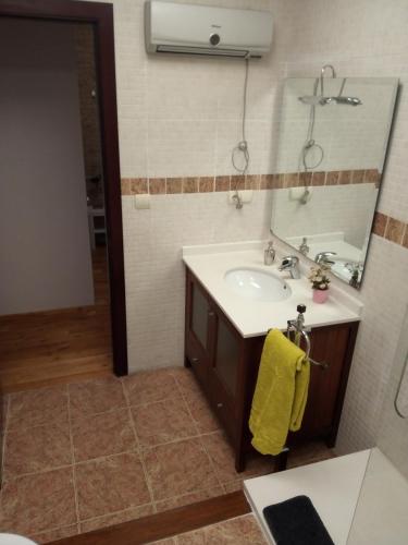 a bathroom with a sink and a mirror at Espai One Valencia in Valencia