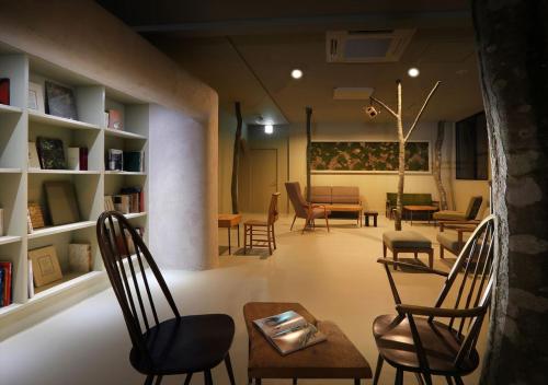 a living room with chairs and a table at Oyado Morinone in Kaminoyama