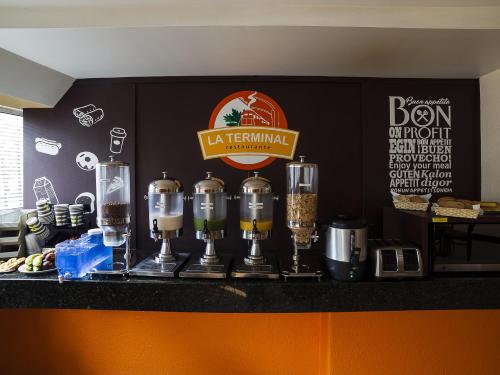 a counter with a group of coffee machines on it at Hotel Via La Villa in Mexico City