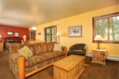 a living room with a couch and a table at The Forest Neighborhood by Keystone Resort in Keystone