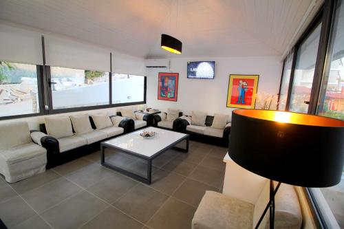 a living room with couches and a table at Olympia Hotel in Sarandë