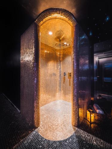 a bathroom with a walk in shower with a mirror at Hotel Pacai, Vilnius, a Member of Design Hotels in Vilnius