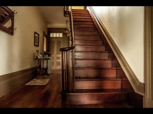 a wooden staircase in a home with a wooden floor at Culverdene House in Simcoe