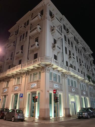 a large white building with cars parked in front of it at Berga Exclusive Suite 5 in Bari