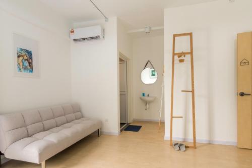 a living room with a couch and a sink at Minima 8 in George Town