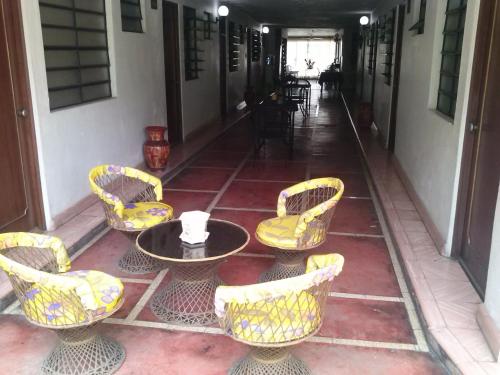 a group of chairs and a table on a patio at Hotel Posada del Angel in Mérida