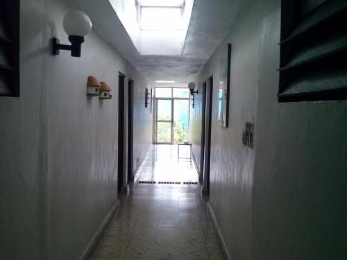 a hallway with a light at the end of a room at Hotel Posada del Angel in Mérida