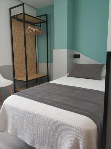 
a bedroom with a bed and a mirror at Hotel Abelay in Palma de Mallorca
