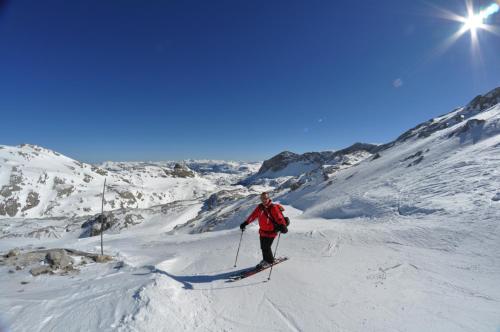 a man is skiing down a snow covered mountain at Apparthotel Bliem in Schladming