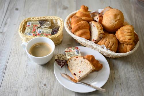 a table with a plate of bread and a cup of coffee at Hotel Mystays Nayoro in Nayoro