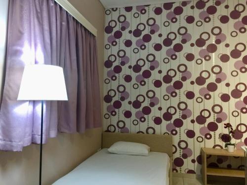 a bedroom with a bed and a wall with a pattern at Villa Sofia in Chrani