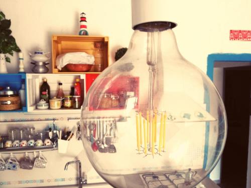 a large glass vase sitting on top of a counter at Casa GIOLE in Punta Secca