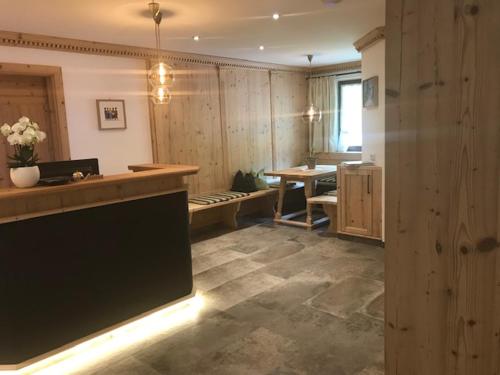 a large room with a large television and a table at Hotel Garni Senn in Sankt Anton am Arlberg