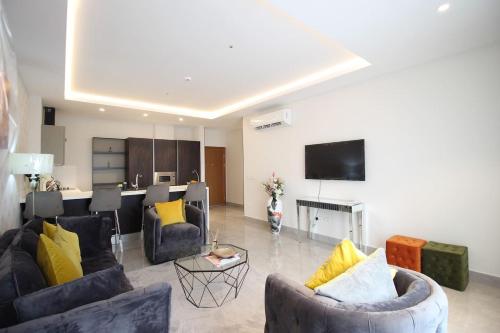 a large living room with couches and a table at APARTMENTS GH - Accra - Airport Residential Area - Mirage Residence in Accra