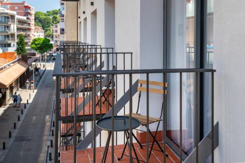 a group of chairs sitting on a balcony at GHT Miratge - Only Adults 18 and up in Lloret de Mar