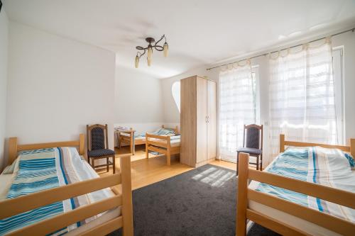 a bedroom with two bunk beds and a desk at Villa Ami in Novi Sad