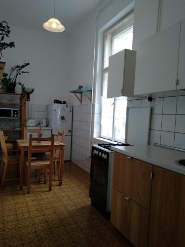 a kitchen with a table and a dining room at HoBar Hostel in Budapest