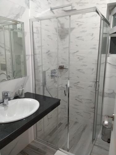 a bathroom with a shower and a sink at Brb rooms in Himare