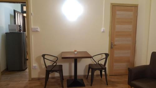 a small table and two chairs in a living room at The Monalysa Suites & Residence in Grand Baie