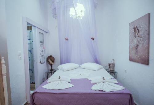 a bedroom with a bed with white sheets and pillows at Studio Lefaki in Rethymno Town