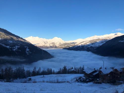 a view of a valley with snow covered mountains at Black Diamond Sainte Foy Chalets in Sainte-Foy-Tarentaise