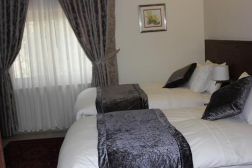 a hotel room with two beds and a window at Lavender Boutique Hotel in Ramallah