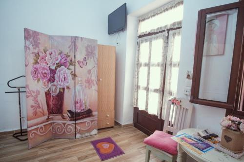 a living room with a painting of flowers on the wall at Studio Lefaki in Rethymno Town