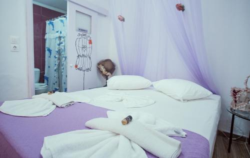 a bedroom with a bed with towels on it at Studio Lefaki in Rethymno Town