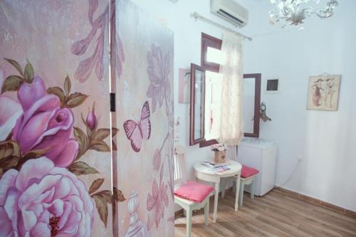 a room with a pink flower mural on the wall at Studio Lefaki in Rethymno Town