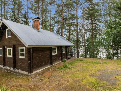 a small house on a hill in the woods at Holiday Home Keskimökki by Interhome in Tasapää