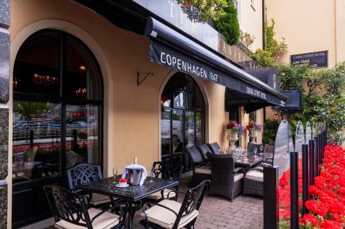 a restaurant with tables and chairs outside of a building at Canal Court in Newry