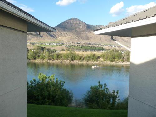 a view of a river with a boat in it at Riverland Inn & Suites in Kamloops