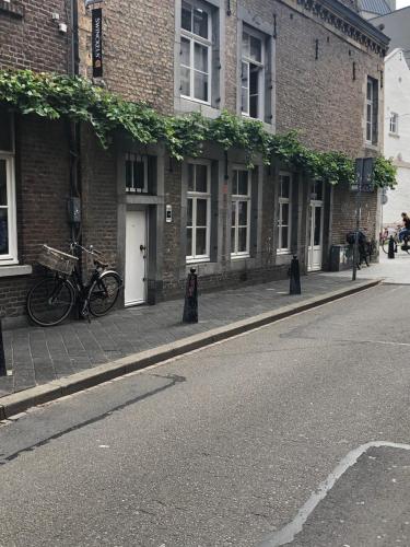 a building with bikes parked outside of it on a street at B&B Gracht 62 in Maastricht