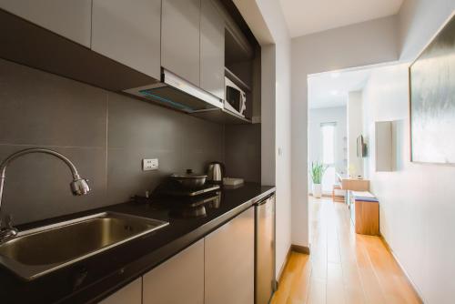 a kitchen with a sink and a counter at Nexy Living in Hanoi