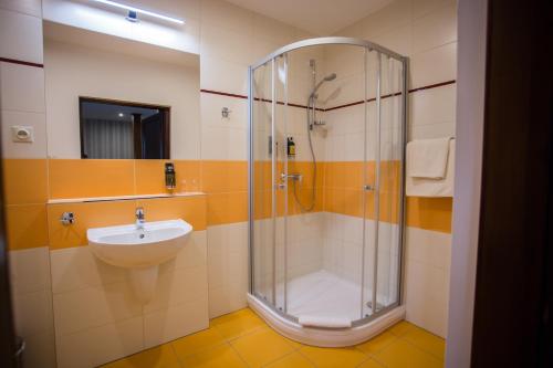 a bathroom with a shower and a sink at Resort Malevil in Jablonné v Podještědí