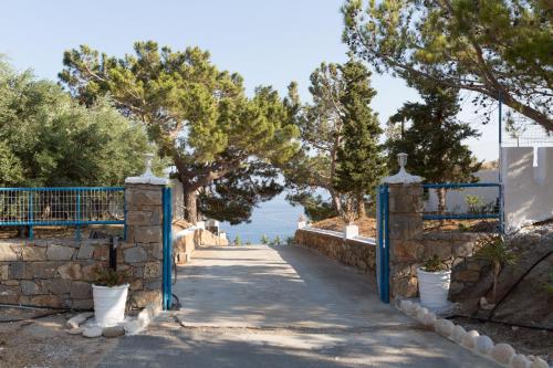 a gate to a path with a view of the ocean at Ferma Hill Apartments in Ferma