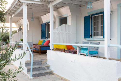 a porch of a house with a table and chairs at Ferma Hill Apartments in Ferma