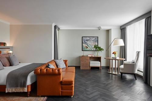 a hotel room with a bed and a chair at Kimpton Charlotte Square by IHG in Edinburgh