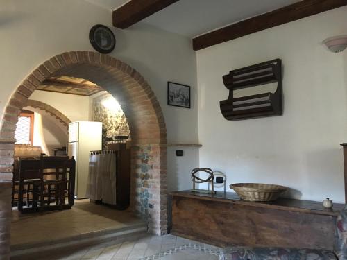 a kitchen with an archway and a refrigerator in a room at Casa Vacanze Crocevia in Badolato