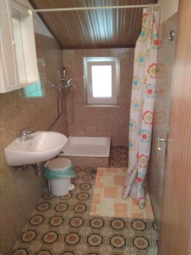 a bathroom with a sink and a tub and a toilet at Gostišče Oddih in Solkan