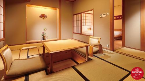 a room with a table and a chair and a desk at Radium Kagaya Taipei in Taipei