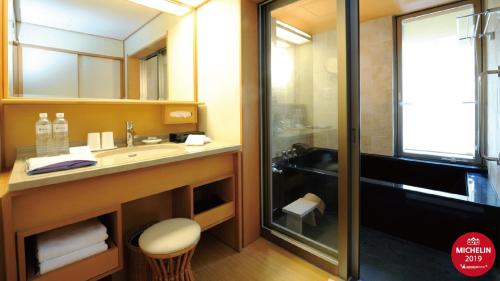 a bathroom with a sink and a shower at Radium Kagaya Taipei in Taipei