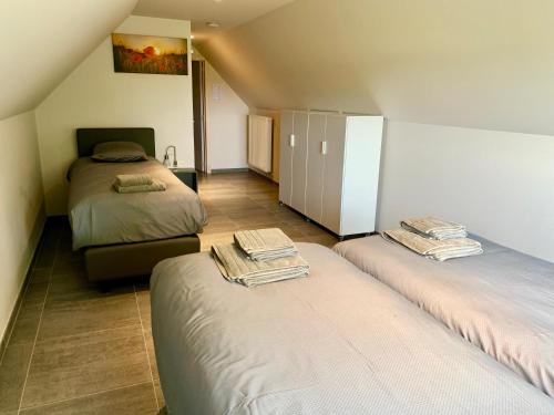 En eller flere senge i et værelse på Vakantiewoning Ter Luyghem