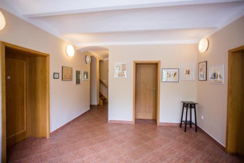 a hallway with a door and a stool in a room at Resort Malevil in Jablonné v Podještědí